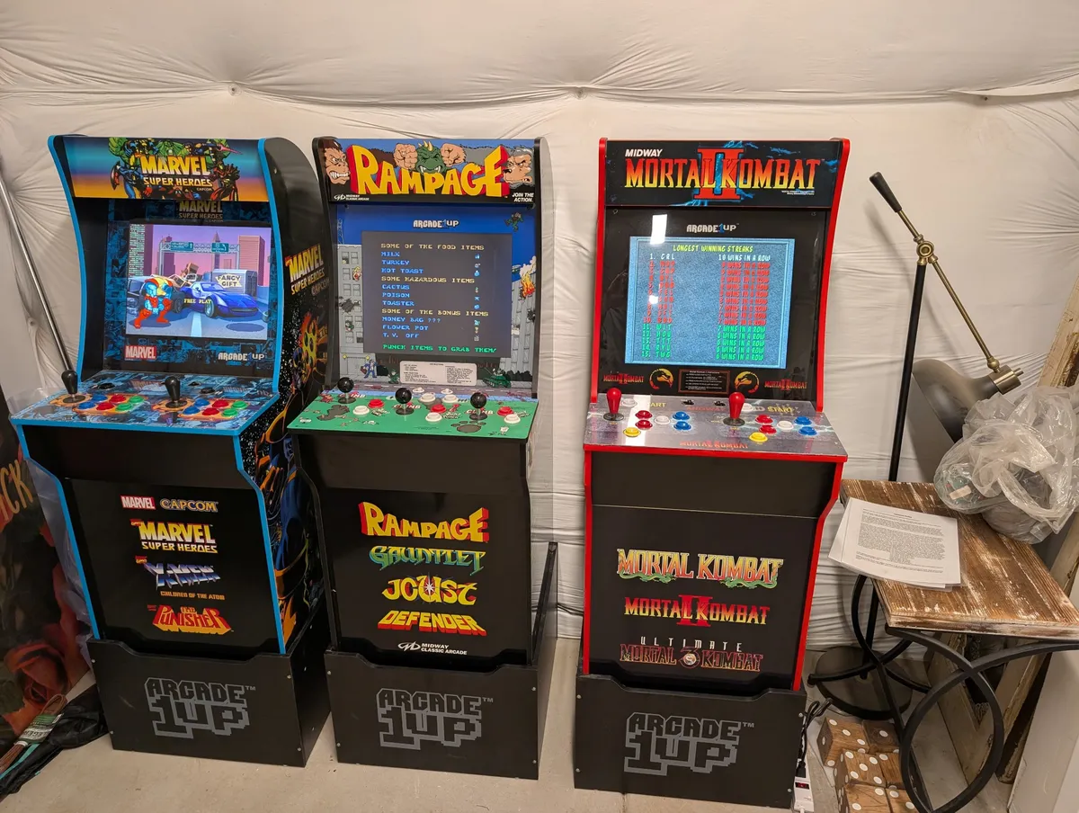 This image captures a vibrant game zone featuring multiple arcade machines with bright screen graphics and colorful wall art, inviting energetic play and friendly competition. The lively, playful atmosphere is perfect for all ages to gather and create memories.